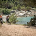 Dwie rowerzystki gravel jadą nad adriatyckim klifowym wybrzeżem